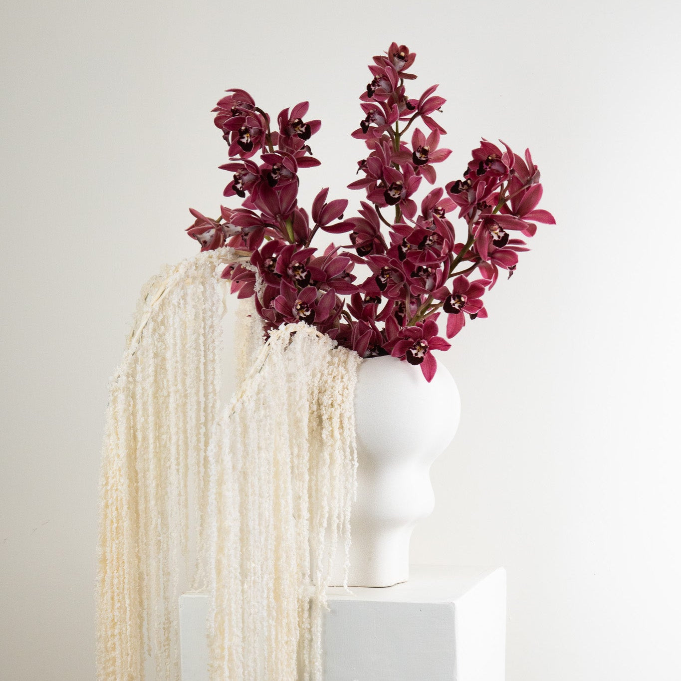modern floral arrangement with cymbidium orchids and amaranthus